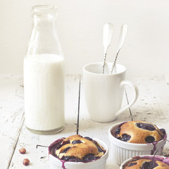 vintage polaroid of clafoutis with blueberries and bottled milk