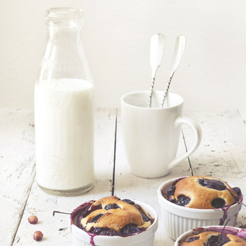 vintage polaroid of clafoutis with blueberries and bottled milk