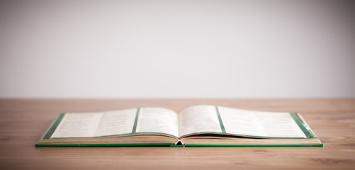 Open book on wooden deck