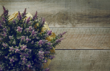 heather flowers over rustic wooden background.