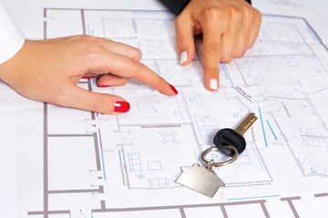 Isolated house key on top of house project.