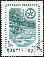 Obraz premium stamp printed in the Hungary shows Waterfall and Forest