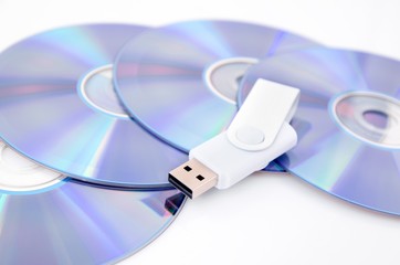 DVD disc and USB flash drive on white background