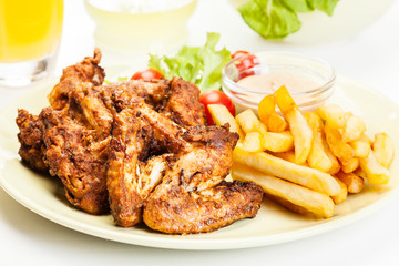 Chicken wings with fries french and spicy sauce