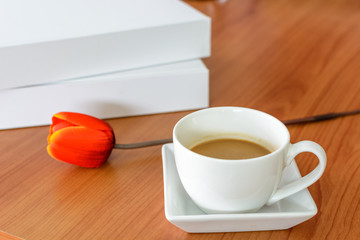 cup of coffee with tulip and book