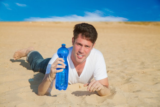 Caucasian man with water in desert