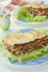 The traditional Italian national dish - beef lasagna with salad.