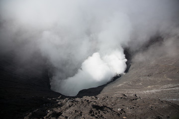 Active volcano crater with smoke