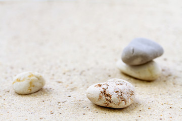 Fototapeta na wymiar Stack of stones on sand beach