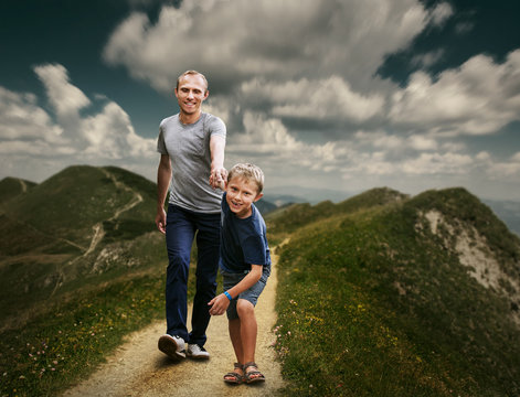 Son with father running on the footpath