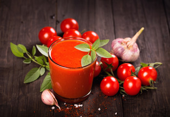 Tomato juice glass with basil and tomatoes