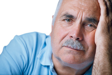 Lonely old man with hand on his face