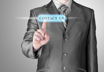 Businessman pushing CONTACT US sign