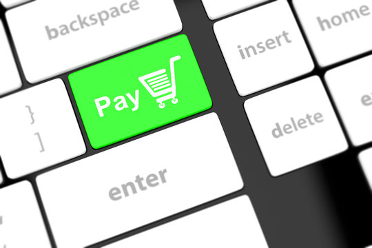 Pay key with shopping cart icon on a white keyboard