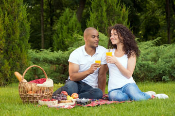 Happy young couple spending time together in park