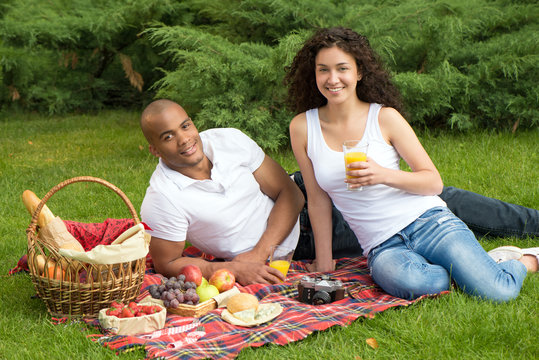 Happy international couple having a picnic