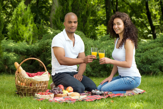 Happy romantic couple enjoying picnic in a park