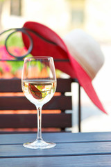 Glass of delicious white wine in summer restaurant. Outdoors.
