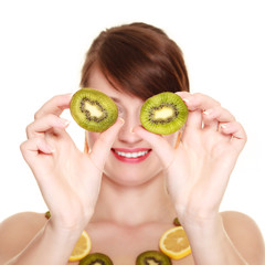 Girl in fruit necklace covering eyes with kiwi