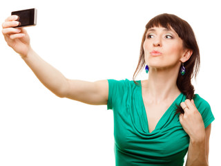 Naklejka premium Happy woman taking self picture with smartphone