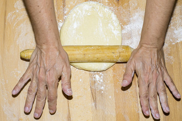 Hands with rolling kneading dough