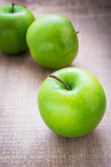 Green apple on wooden background