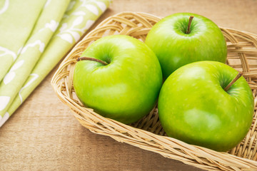 Green apple in wicker basket, filtered image