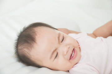 Fototapeta na wymiar Asian cute girl baby lying in bed