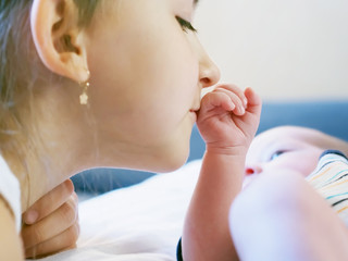 Caucasian child sister and baby brother lying together at home