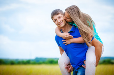 Romantic couple relaxing in field