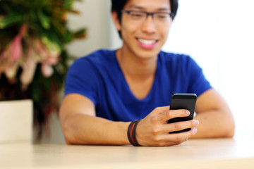 Closeup portrait of a man using smartphone. Focus on smartphone