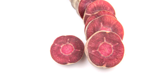Chopped purple carrot over white background