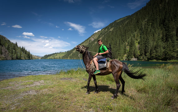 Travelling On Horseback On A Mountain Lake