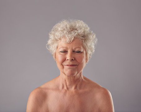 Attractive Senior Woman With Her Eyes Closed In Thought