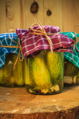 Jars pickled gherkins wooden table