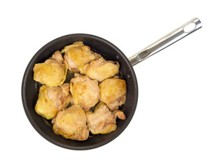 Top view of skillet with cooked chicken thighs