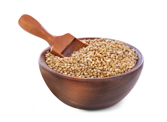 Ripe wheat in a wooden bowl isolated on white background