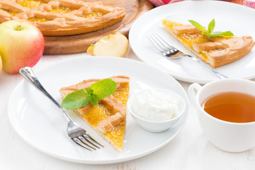 piece of fresh apple pie with whipped cream and cup of tea