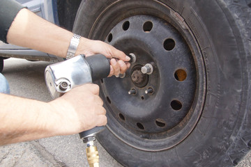 Auto mechanic changing car wheel