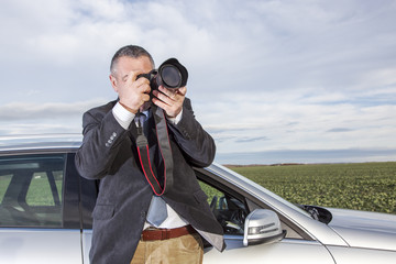 Man standing in front of the car and photographed