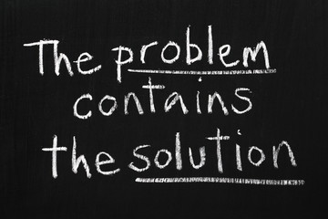 Obraz premium The Problem contains the Solution written on a blackboad