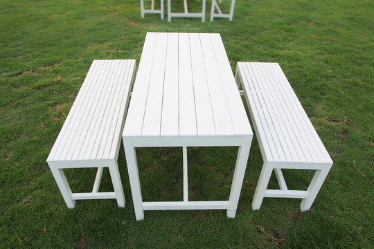 A set of white table and benches