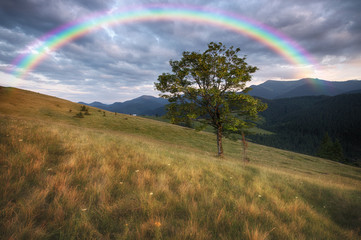 Mountains rural landscape and rainbow