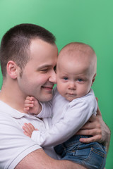 Happy smiling father embracing his baby boy