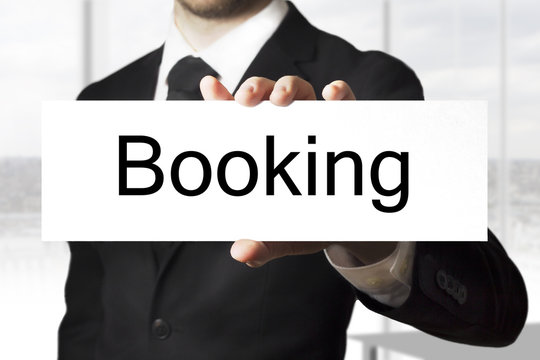businessman holding sign booking