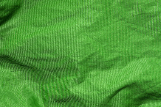 green shiny cloth texture or background