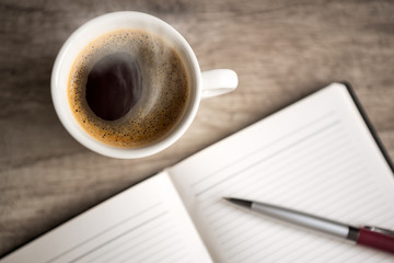 open empty notebook with coffee cup