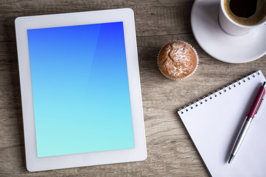 Ipad Tablet With Cup Of Coffee Over Wooden Table