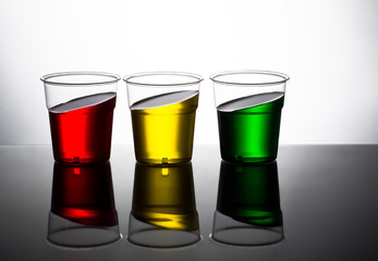 Traffic light colour drinks, slanted. Red yellow and green. Stop