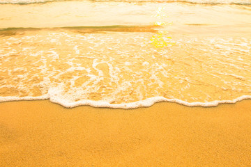 Beach sand texture. Soft wave of the sea.